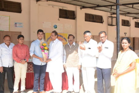 Hon. Govardhanji Sharma honouring Mst. Aditya Sawarkar National player of Rifle shooting.